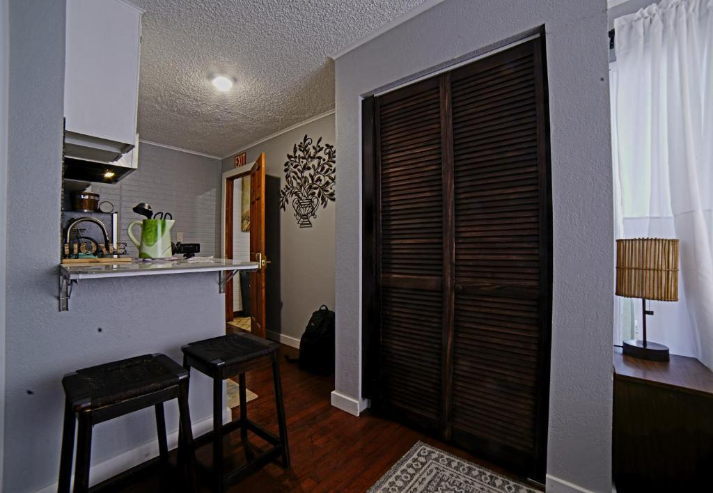 Bedroom with plaid armchair and mirror, ShaligoHomes Queen Suite, Anchorage AK
