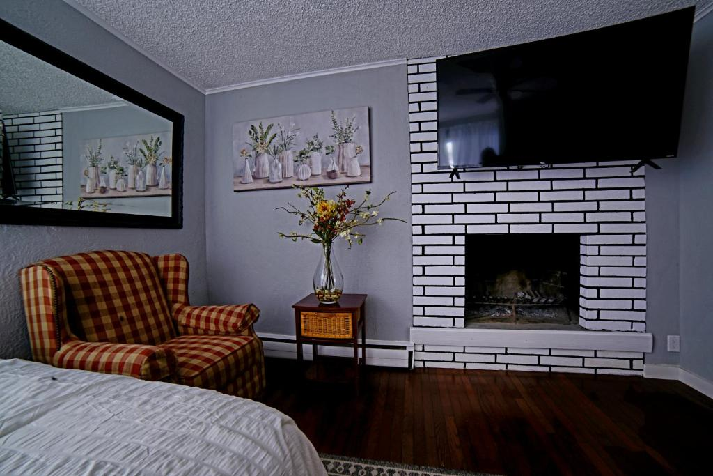 Bedroom with plaid armchair and mirror, ShaligoHomes Queen Suite, Anchorage AK