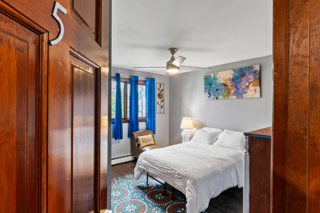 Bedroom with blue curtains and floral art, East 16th Avenue Anchorage