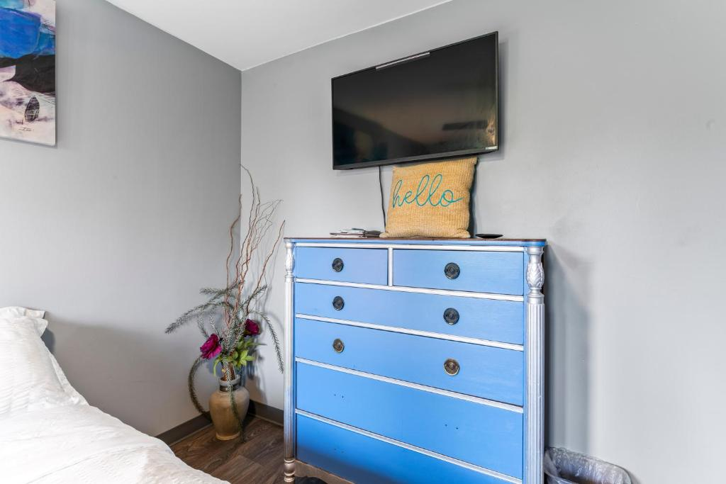 Bedroom with blue curtains and floral art, East 16th Avenue Anchorage