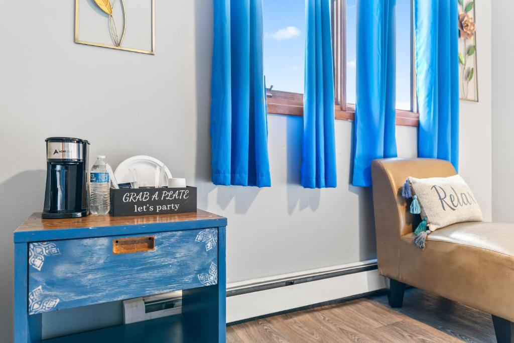 Bedroom with blue curtains and floral art, East 16th Avenue Anchorage