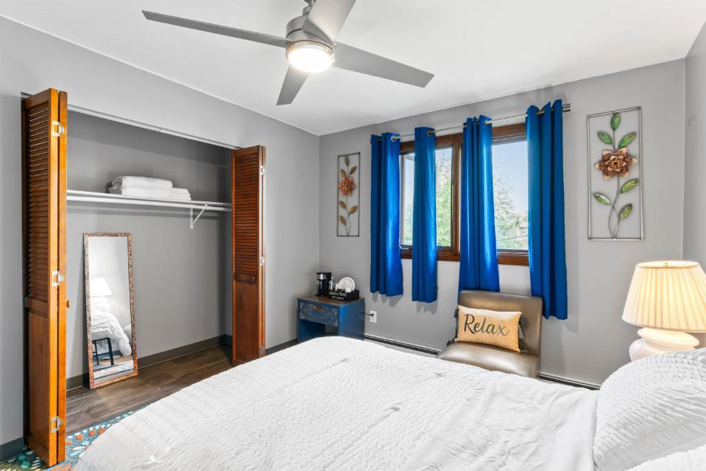 Bedroom with blue curtains and floral art, East 16th Avenue Anchorage