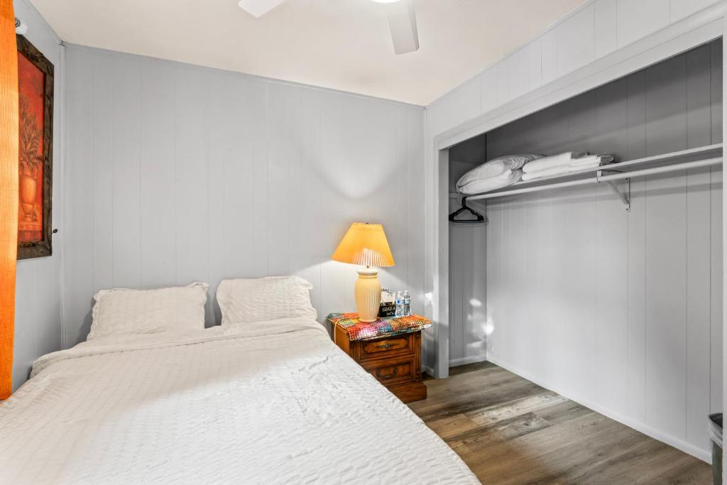 Bedroom with open closet and floral art, Simple And Orange Deluxe, Anchorage