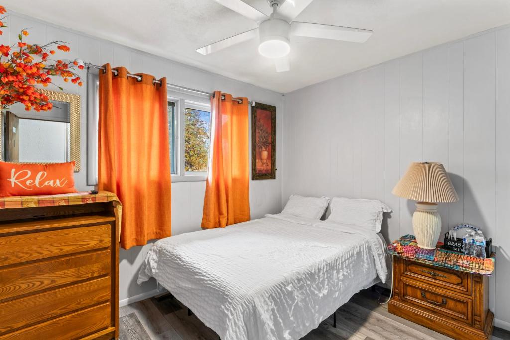 Bedroom with open closet and floral art, Simple And Orange Deluxe, Anchorage