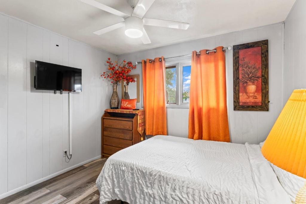 Bedroom with open closet and floral art, Simple And Orange Deluxe, Anchorage
