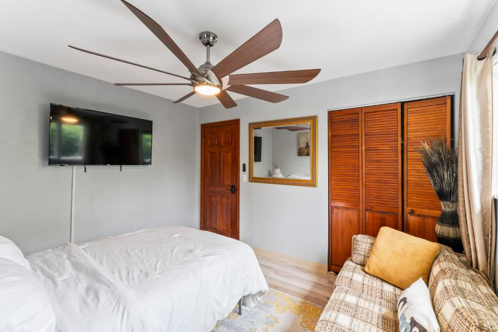 Living area with plaid sofa and Welcome pillow, Stylish Studio Suite, Anchorage