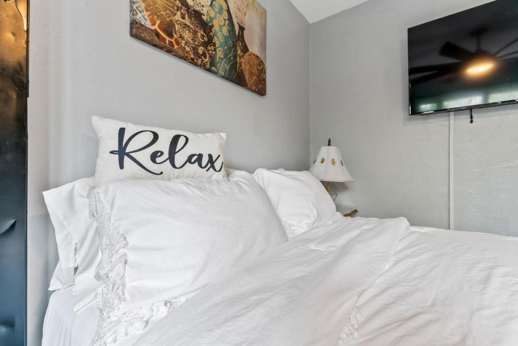 Bedroom area with plaid sofa and Welcome pillow, Stylish Studio Suite, Anchorage